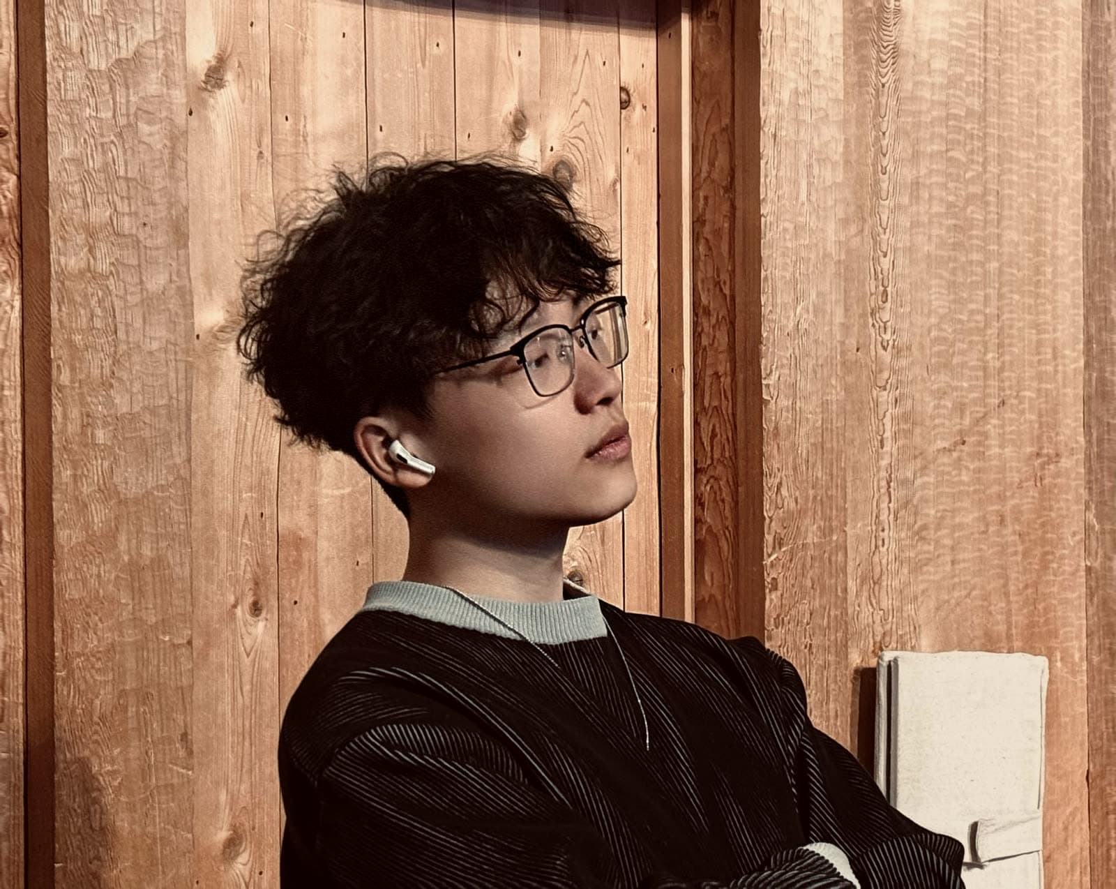 Felix Yang in a reflective moment against a wooden interior